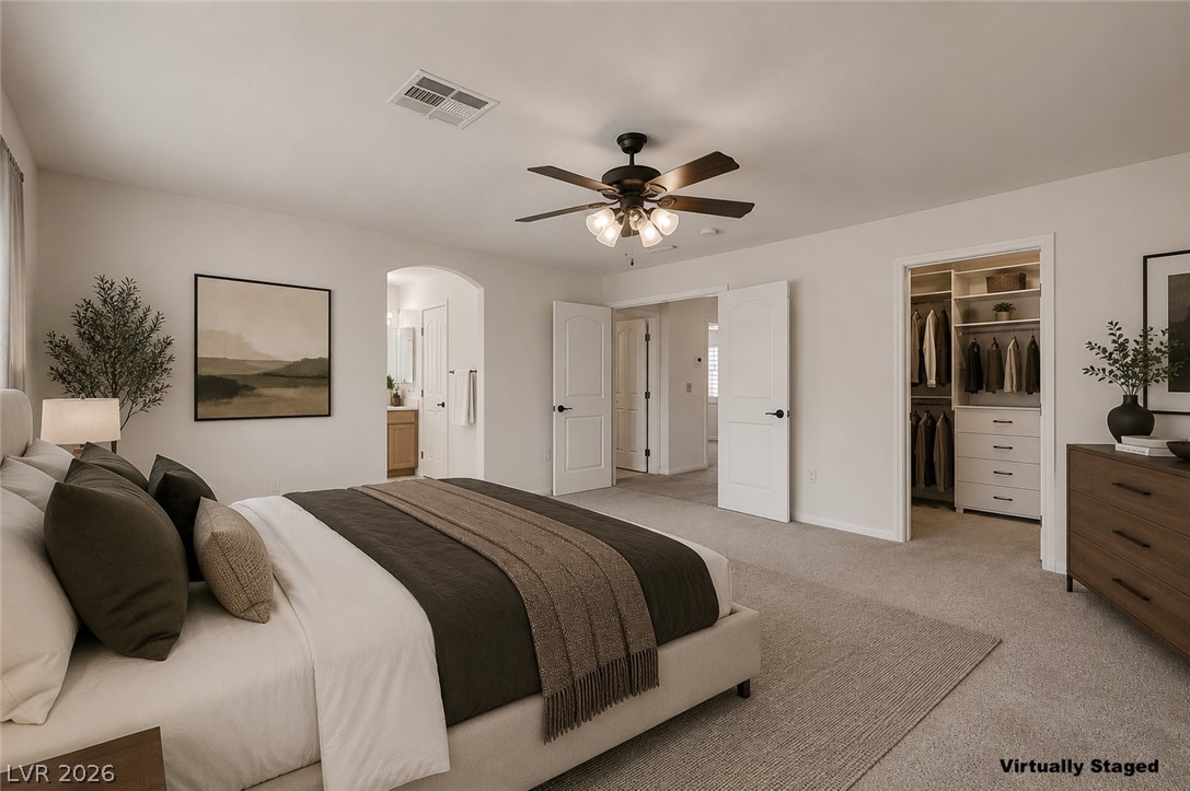1479 Orange Jubilee Road Henderson, NV 89014 - Photo 18 of 36 Well-appointed primary bedroom features a walk-in closet and convenient access to a private bathroom.