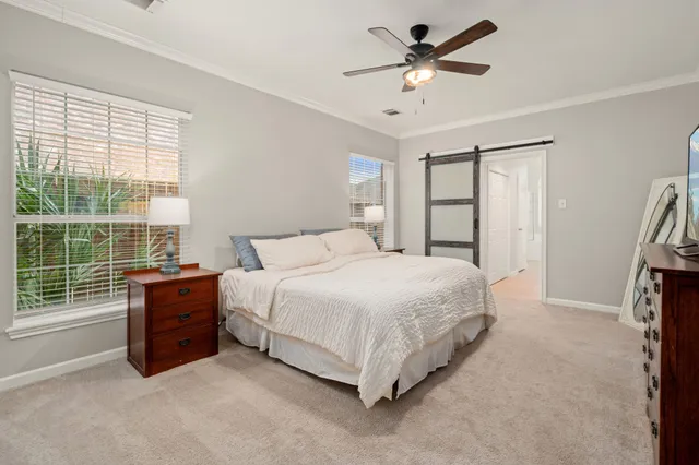 a spacious bedroom with a bed and a large window