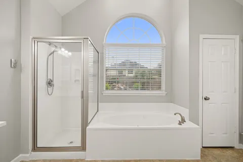 a bathroom with a bathtub and a shower