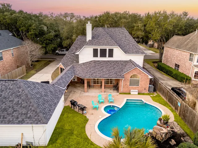 an aerial view of a house with a yard basket ball court and outdoor seating