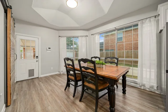 a view of a dining room with furniture and wooden floor