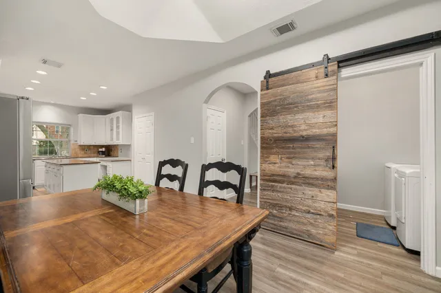 a view of a dining table and kitchen in the house