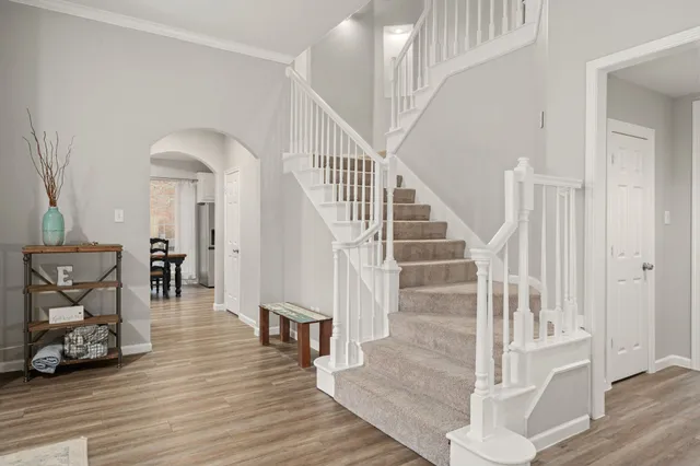 a view of entryway and hall with wooden floor