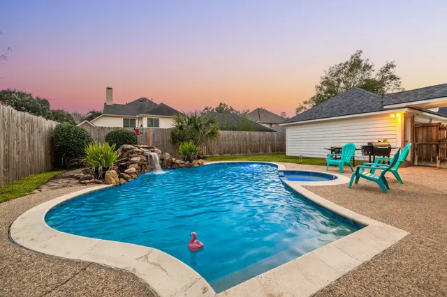 a view of a swimming pool with an outdoor seating