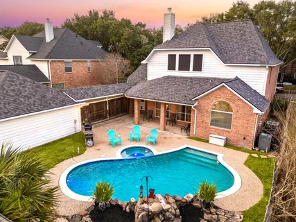 an aerial view of a house with a swimming pool
