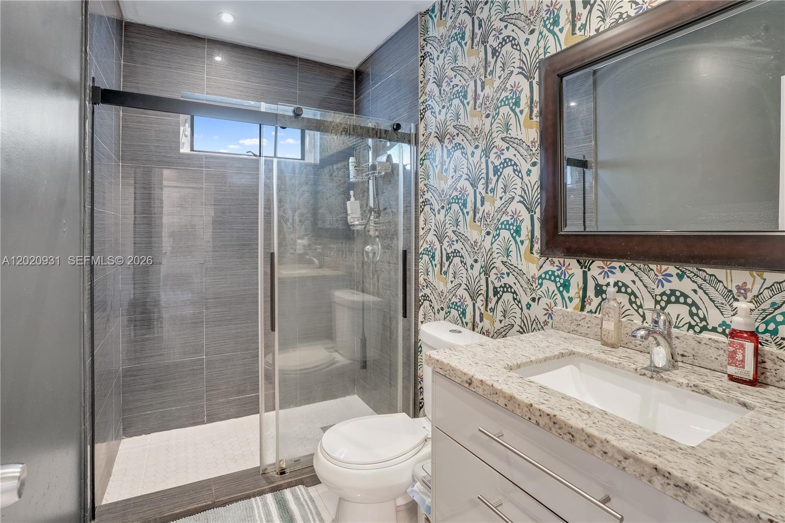 1360 Northwest 77th Street Miami, FL 33147 - Photo 15 of 41 a bathroom with a granite countertop sink toilet and shower