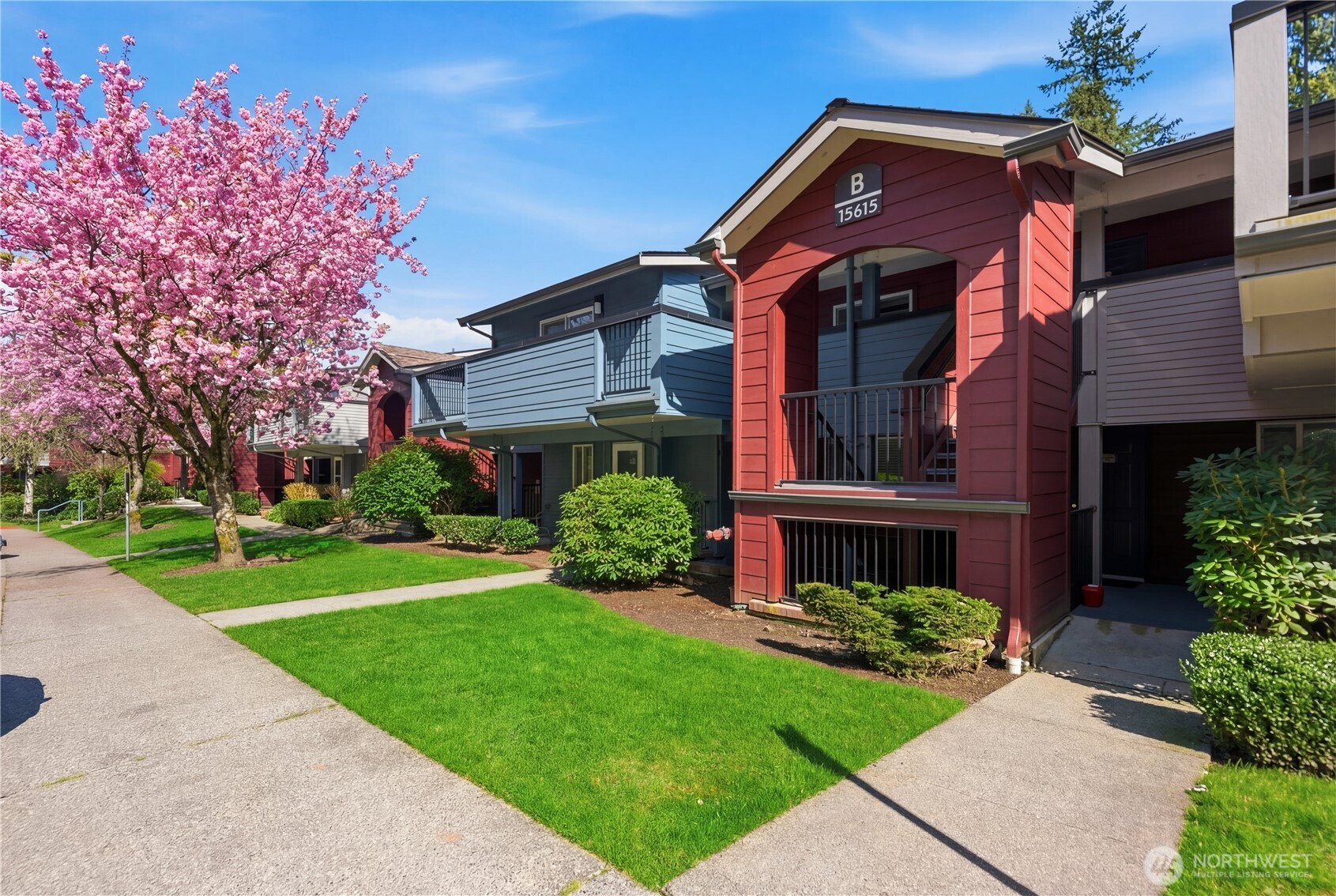 15615 Waynita Way Northeast, Unit B303 Bothell, WA 98011 - Photo 4 of 30 a front view of a house with a yard
