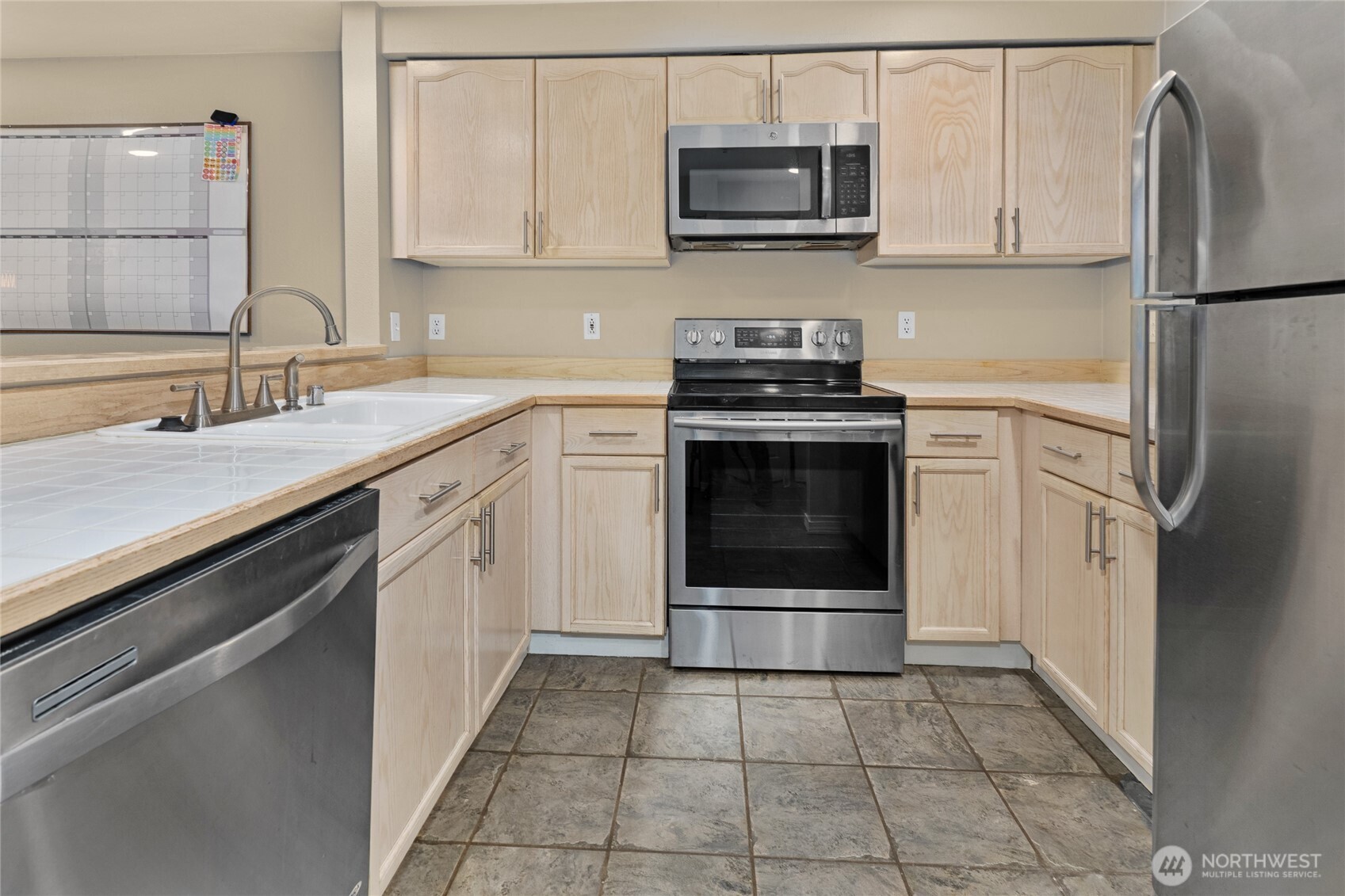 15615 Waynita Way Northeast, Unit B303 Bothell, WA 98011 - Photo 6 of 30 a kitchen with cabinets stainless steel appliances and a sink
