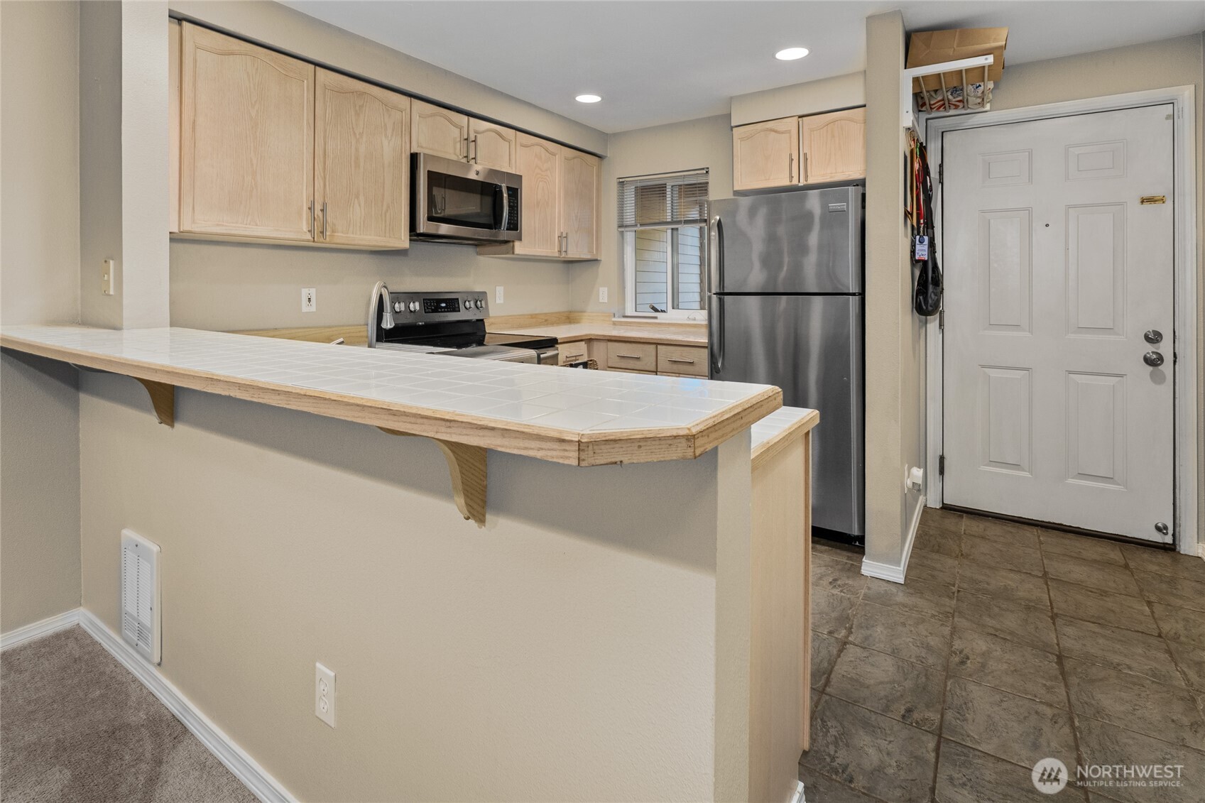 15615 Waynita Way Northeast, Unit B303 Bothell, WA 98011 - Photo 7 of 30 a kitchen with stainless steel appliances a refrigerator sink and microwave
