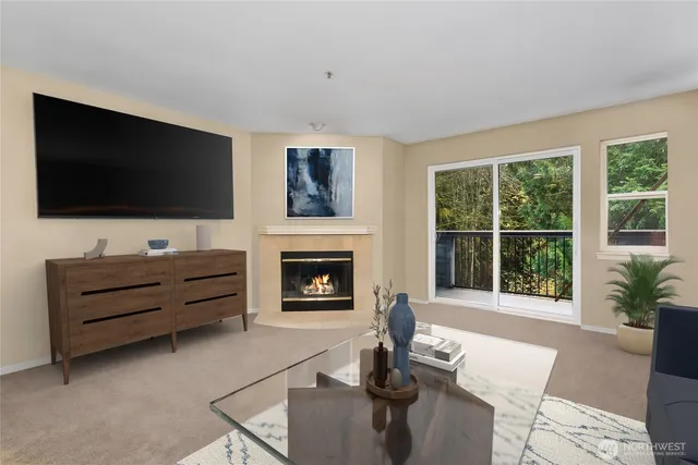 a living room with furniture a flat screen tv and a fireplace