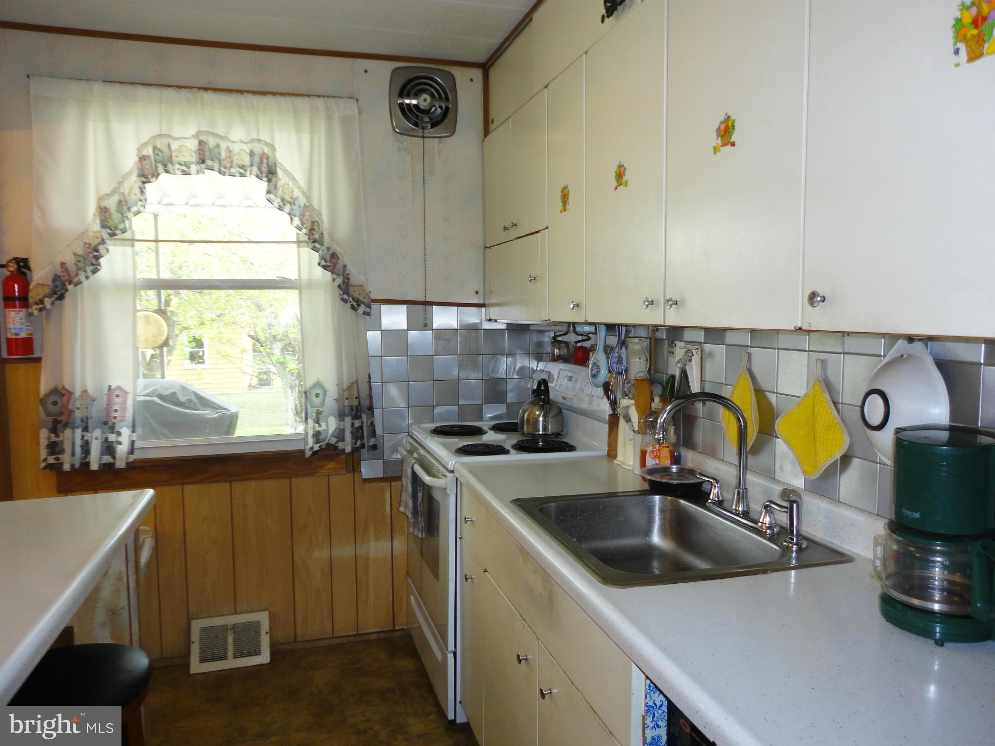 7403 Belclare Road Baltimore, MD 21222 - Photo 14 of 24 a kitchen that has a sink and a stove