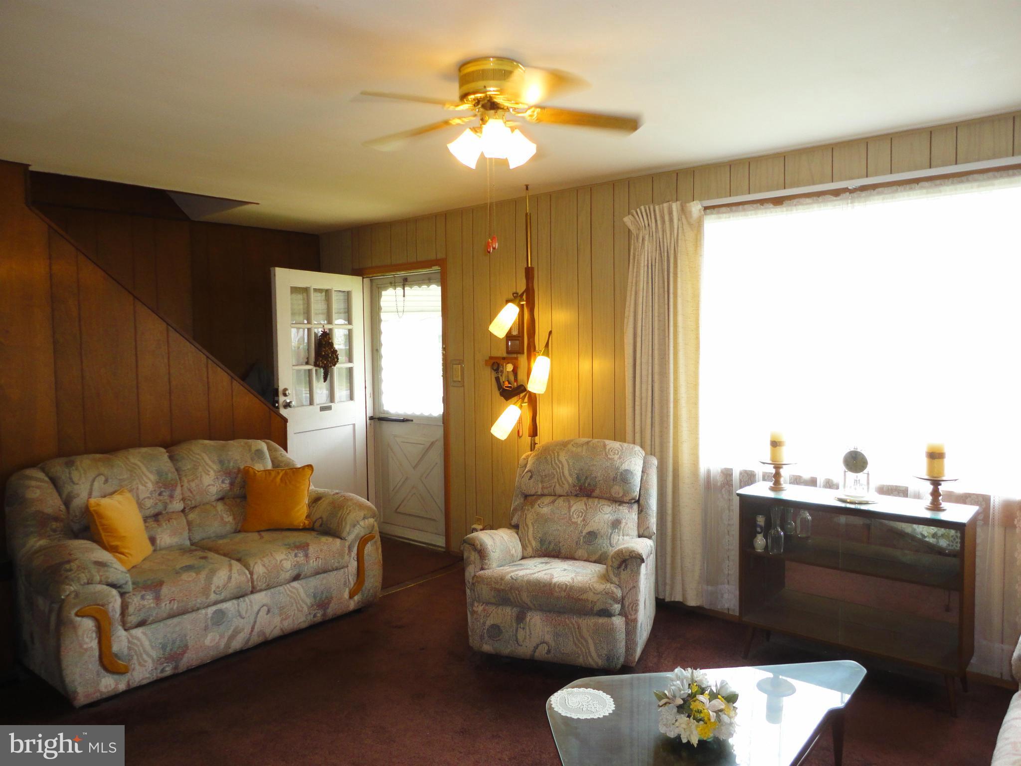 7403 Belclare Road Baltimore, MD 21222 - Photo 8 of 24 a living room with furniture and a chandelier
