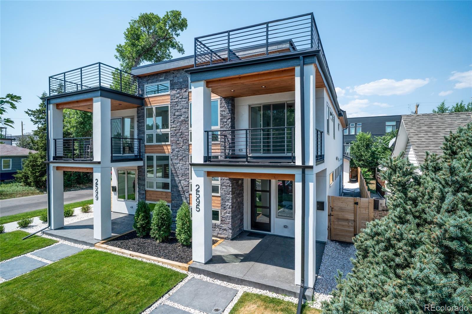 4474 Utica Street Denver, CO 80212 - Photo 2 of 40 a view of a house with a yard and plants