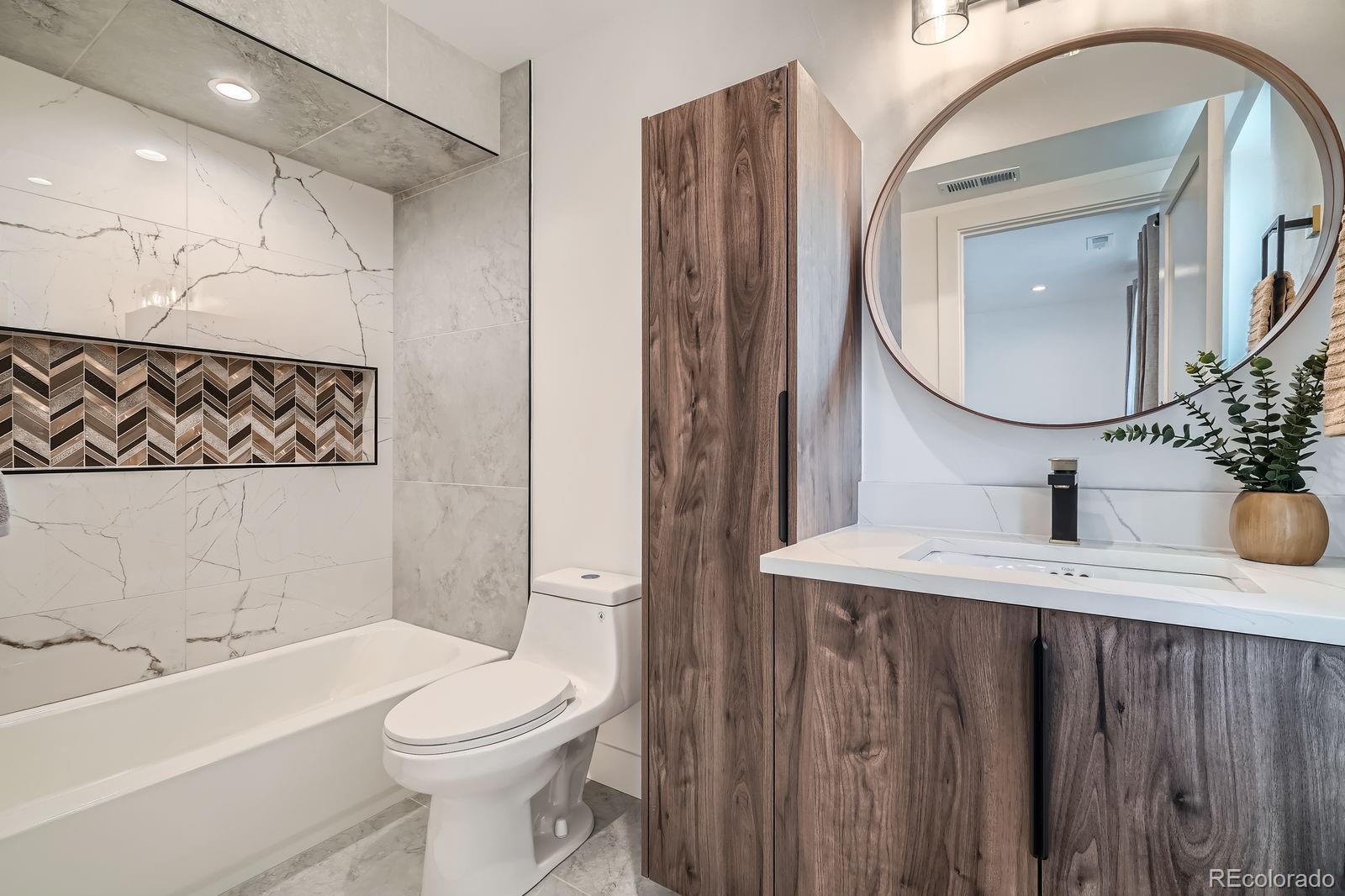 4474 Utica Street Denver, CO 80212 - Photo 24 of 40 a bathroom with a sink a toilet and a mirror