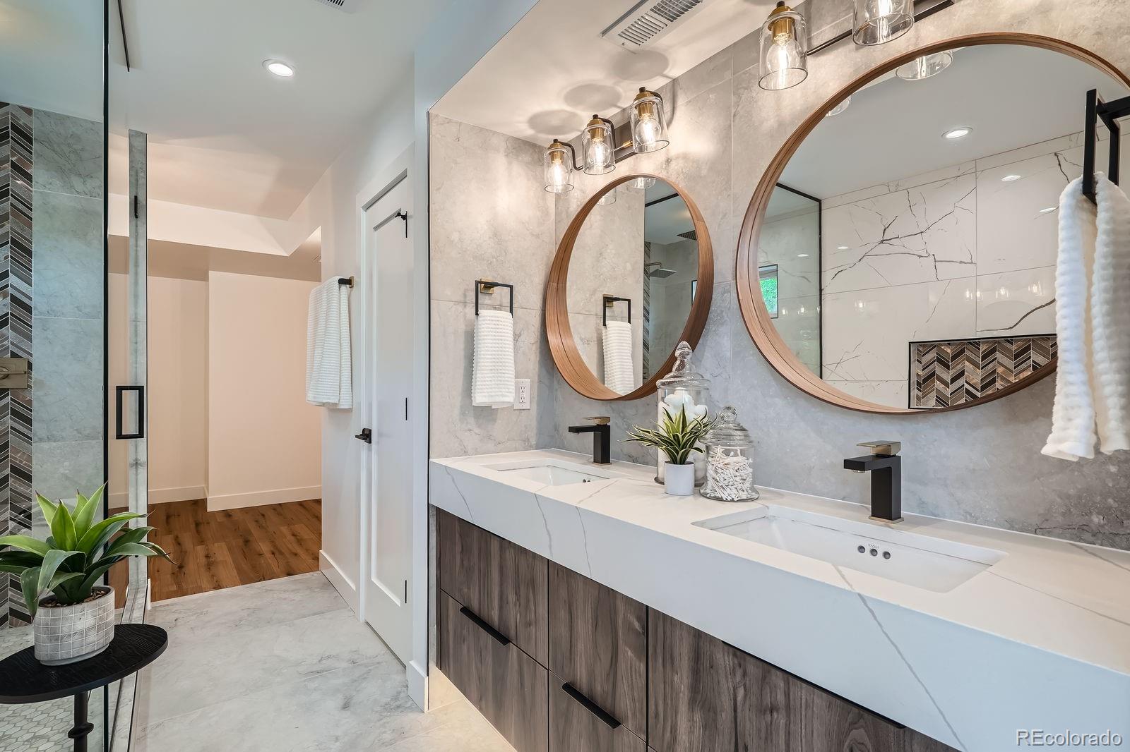 4474 Utica Street Denver, CO 80212 - Photo 25 of 43 a spacious bathroom with a sink a mirror and a shower