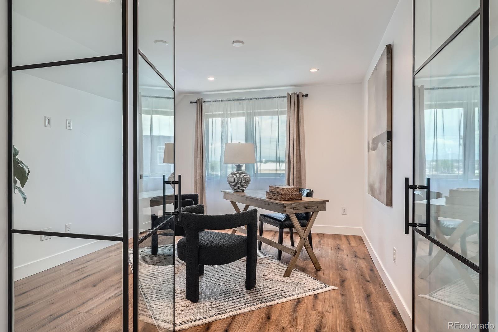 4474 Utica Street Denver, CO 80212 - Photo 26 of 40 a view of a a dining room with furniture window and wooden floor