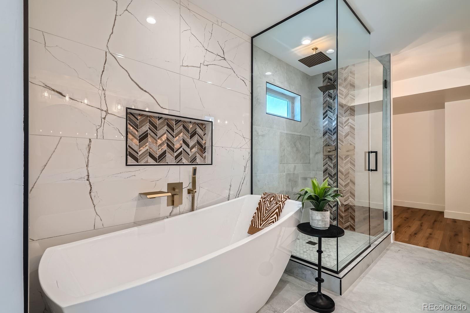 4474 Utica Street Denver, CO 80212 - Photo 26 of 43 a white bath tub sitting next to a white chair and potted plant