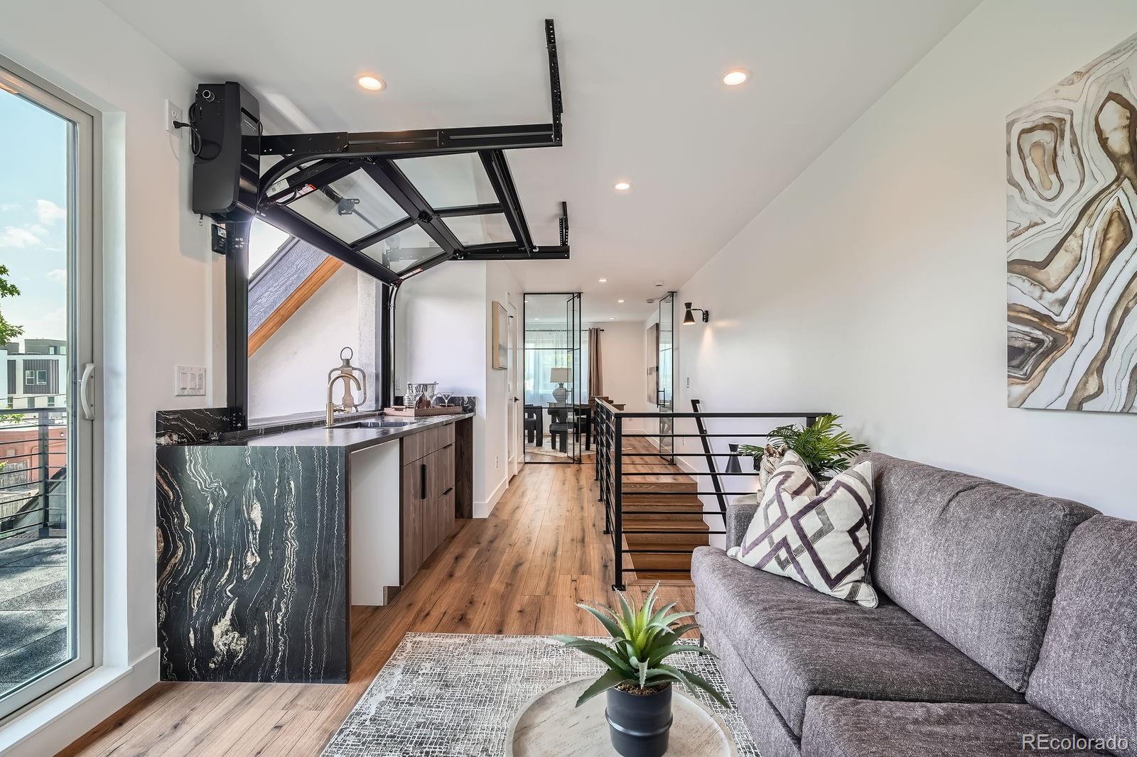 4474 Utica Street Denver, CO 80212 - Photo 29 of 40 a living room with furniture and wooden floor