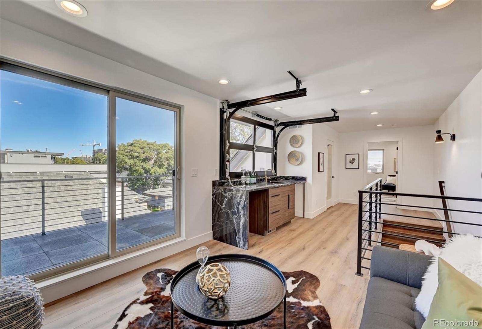 4474 Utica Street Denver, CO 80212 - Photo 30 of 40 a kitchen with stainless steel appliances granite countertop a stove a refrigerator and a sink