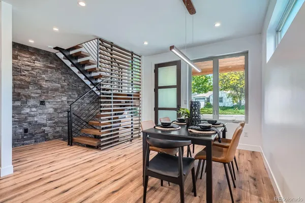 a view of a dining room with furniture and wooden floor