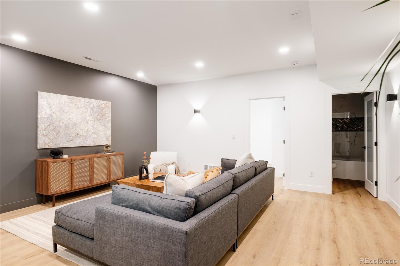 4474 Utica Street Denver, CO 80212 - Photo 37 of 40 a living room with furniture and a flat screen tv