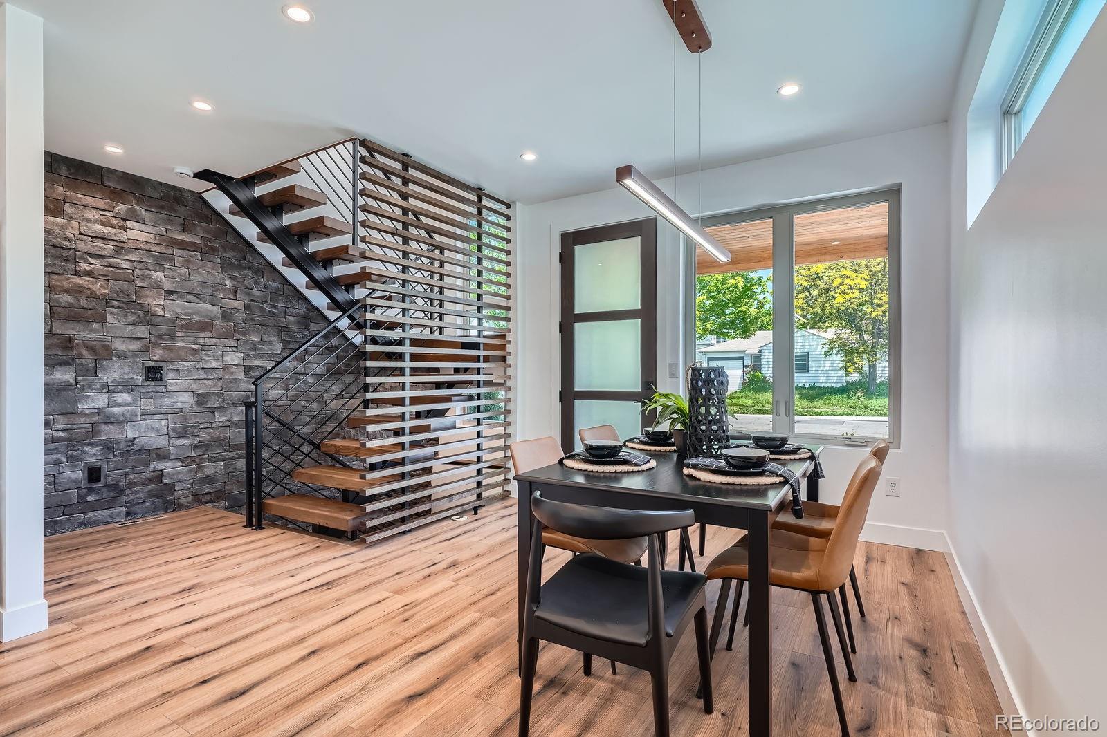 4474 Utica Street Denver, CO 80212 - Photo 5 of 40 a view of a dining room with furniture and wooden floor