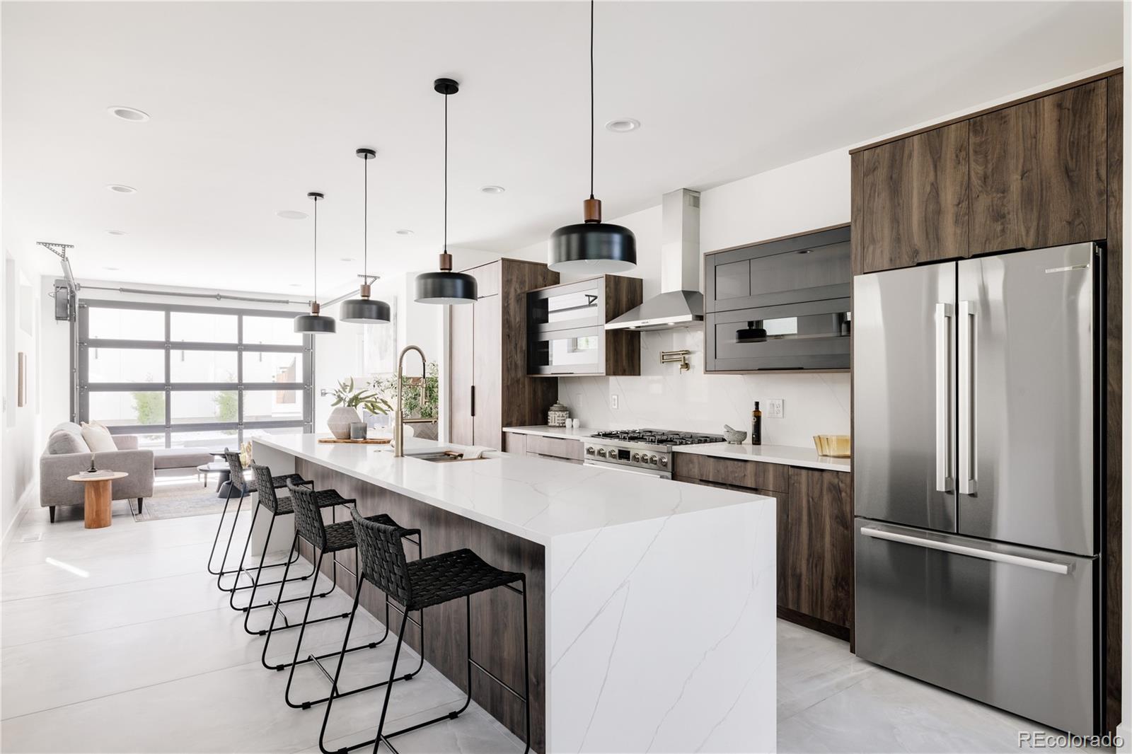 4474 Utica Street Denver, CO 80212 - Photo 10 of 40 a kitchen with stainless steel appliances a refrigerator a stove a sink dishwasher a oven with white cabinets and wooden floor