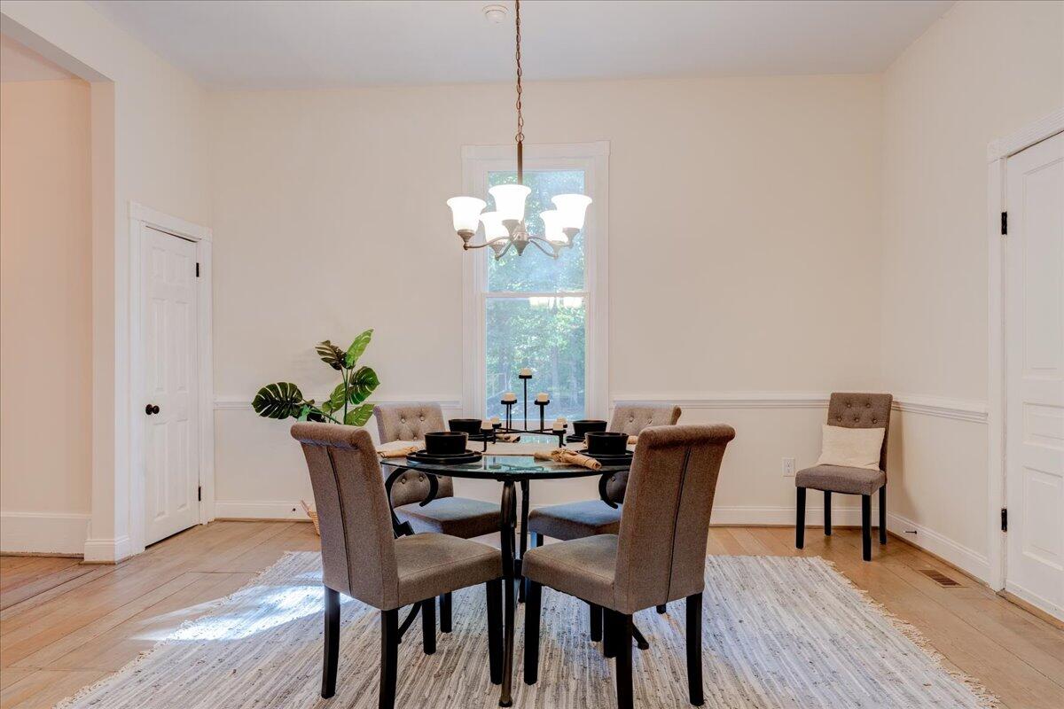 4534 Main Street Drakes Branch, VA 23937 - Photo 15 of 36 a dining room with furniture a potted plant and wooden floor