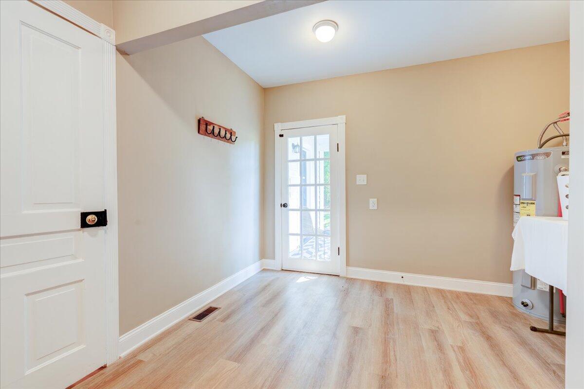 4534 Main Street Drakes Branch, VA 23937 - Photo 18 of 36 an empty room with wooden floor and windows