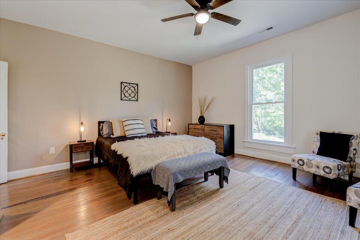 4534 Main Street Drakes Branch, VA 23937 - Photo 23 of 36 a bedroom with a bed and wooden floor