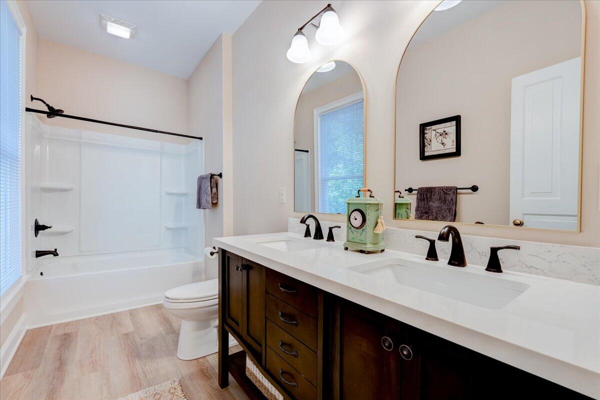4534 Main Street Drakes Branch, VA 23937 - Photo 25 of 36 a bathroom with a tub double sink and mirror