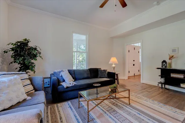 a living room with furniture and a chandelier