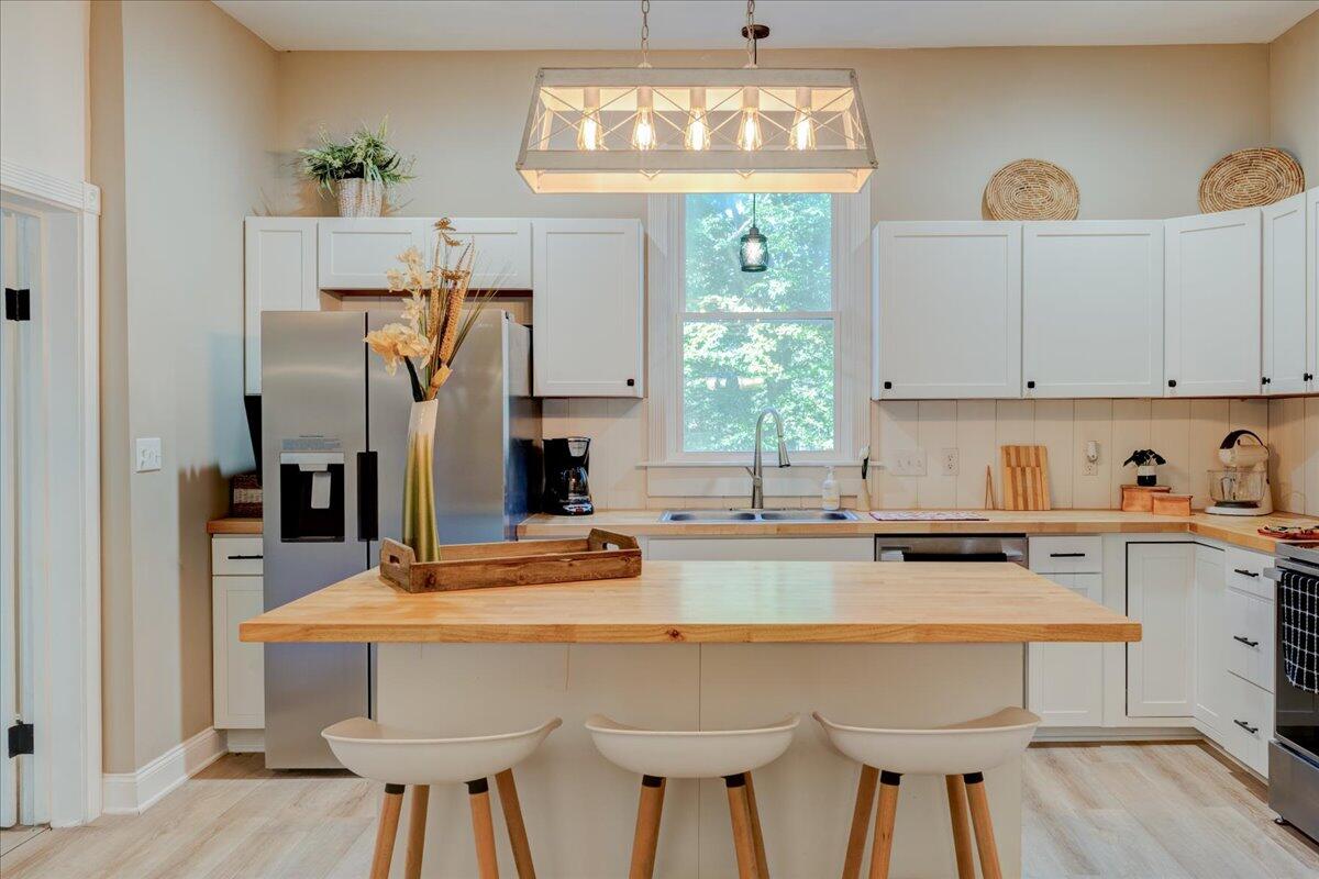 4534 Main Street Drakes Branch, VA 23937 - Photo 9 of 36 a kitchen with stainless steel appliances a dining table chairs and window