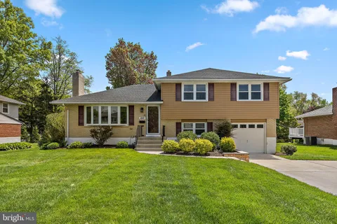 a front view of a house with a garden and yard
