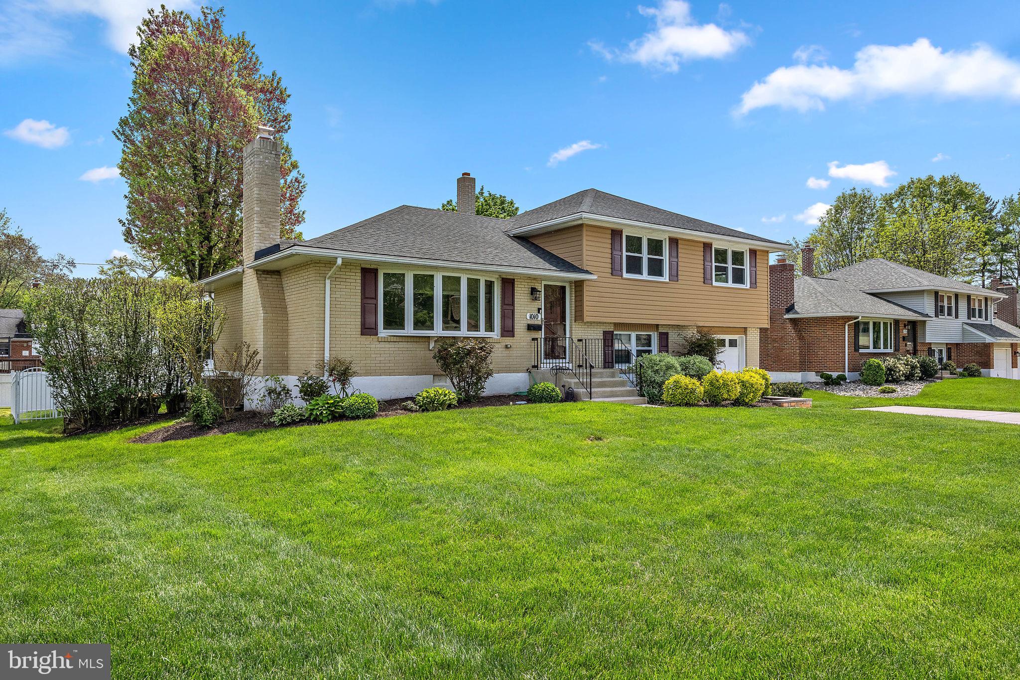 1010 Graylyn Road Wilmington, DE 19803 - Photo 3 of 32 a front view of a house with a garden