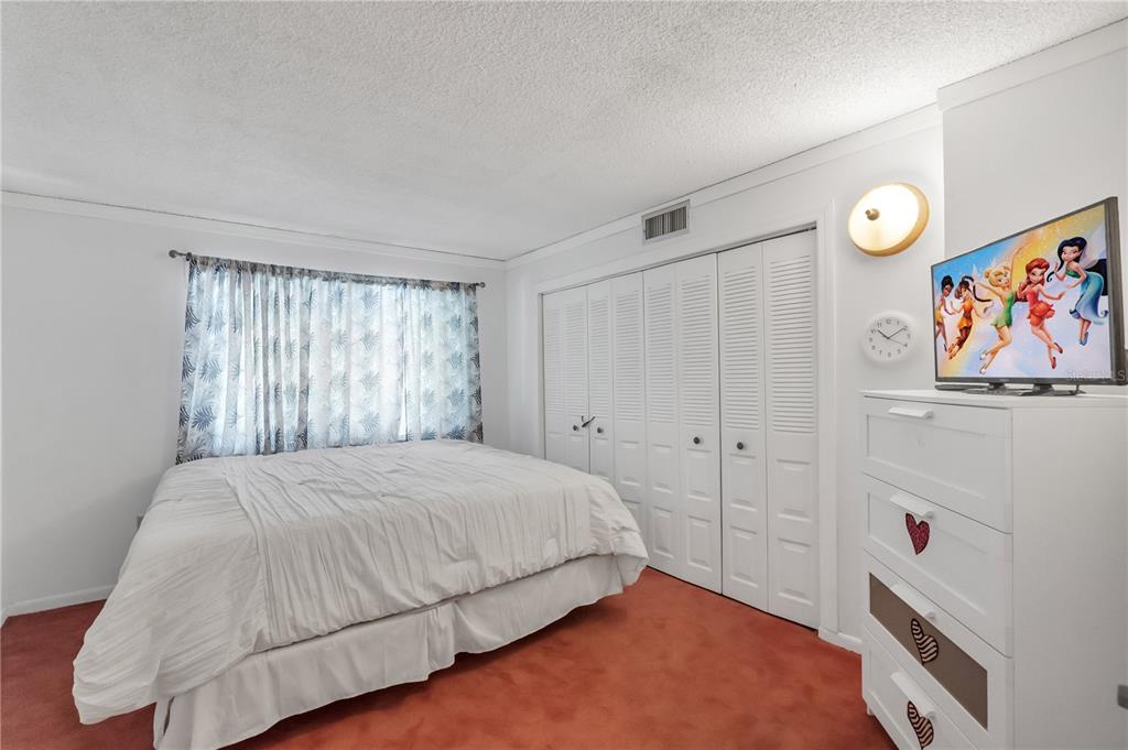 3286 South Semoran Boulevard, Unit 25 Orlando, FL 32822 - Photo 11 of 30 a bedroom with a bed and a window