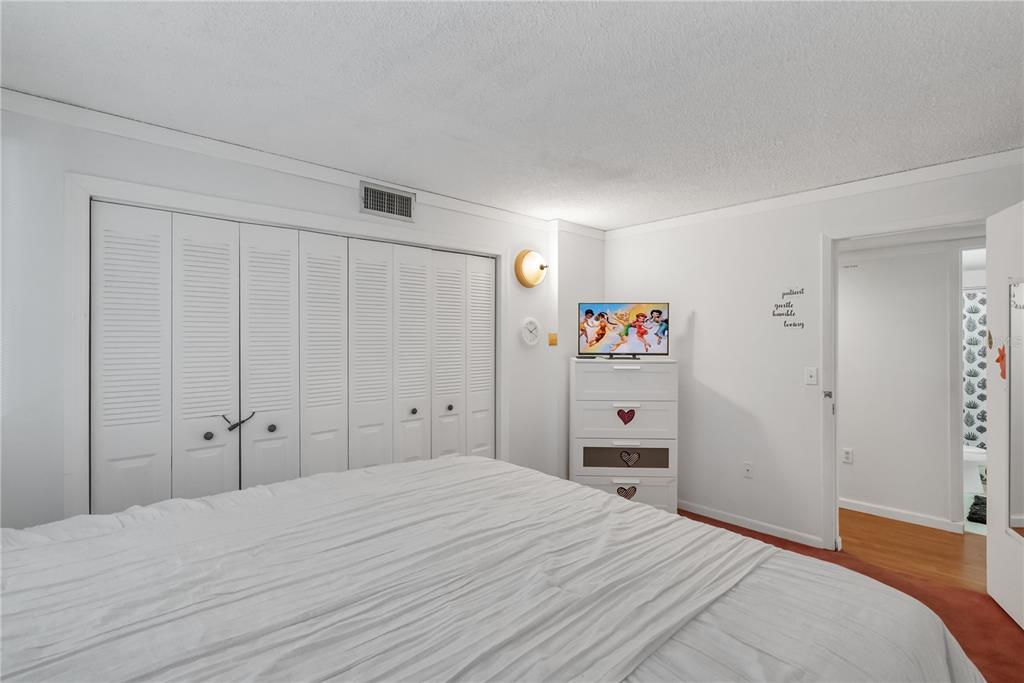 3286 South Semoran Boulevard, Unit 25 Orlando, FL 32822 - Photo 12 of 30 a bedroom with a bed and a closet