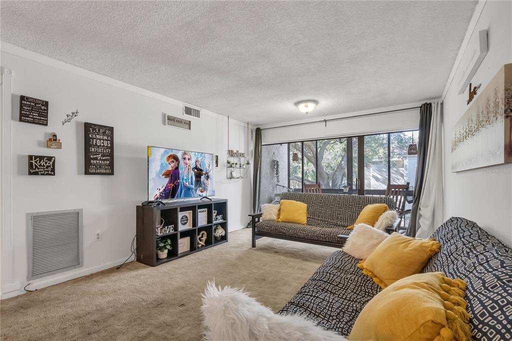 3286 South Semoran Boulevard, Unit 25 Orlando, FL 32822 - Photo 14 of 30 a bed room with couch and a window