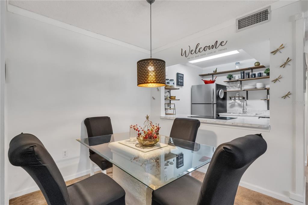 3286 South Semoran Boulevard, Unit 25 Orlando, FL 32822 - Photo 5 of 30 a living room with furniture and a chandelier