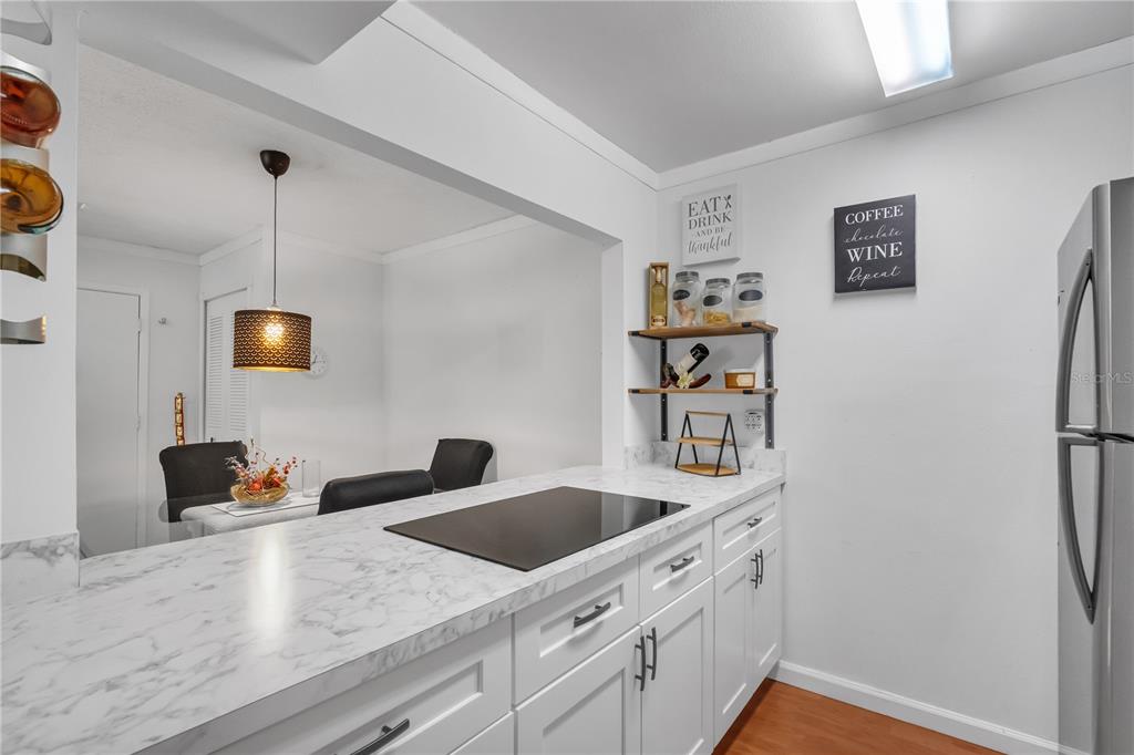 3286 South Semoran Boulevard, Unit 25 Orlando, FL 32822 - Photo 8 of 30 a kitchen with stainless steel appliances granite countertop a refrigerator and a sink