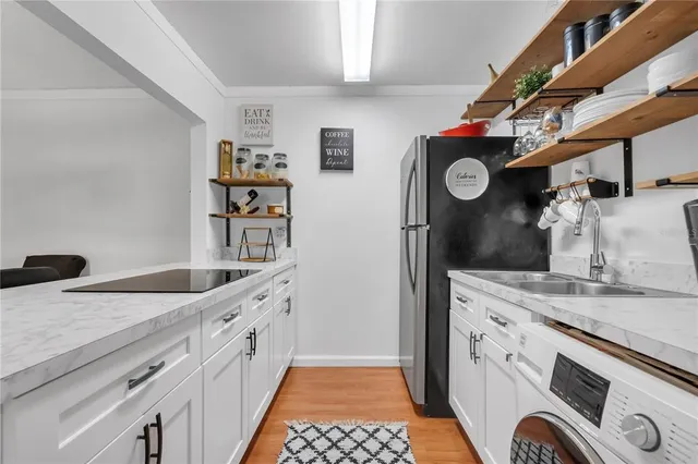 a kitchen with a sink and a stove top oven
