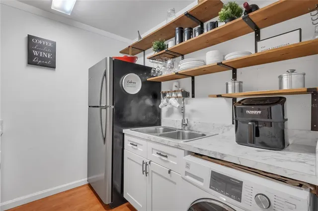 a kitchen with a refrigerator and cabinets