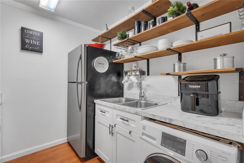 3286 South Semoran Boulevard, Unit 25 Orlando, FL 32822 - Photo 10 of 30 a kitchen with a refrigerator and cabinets
