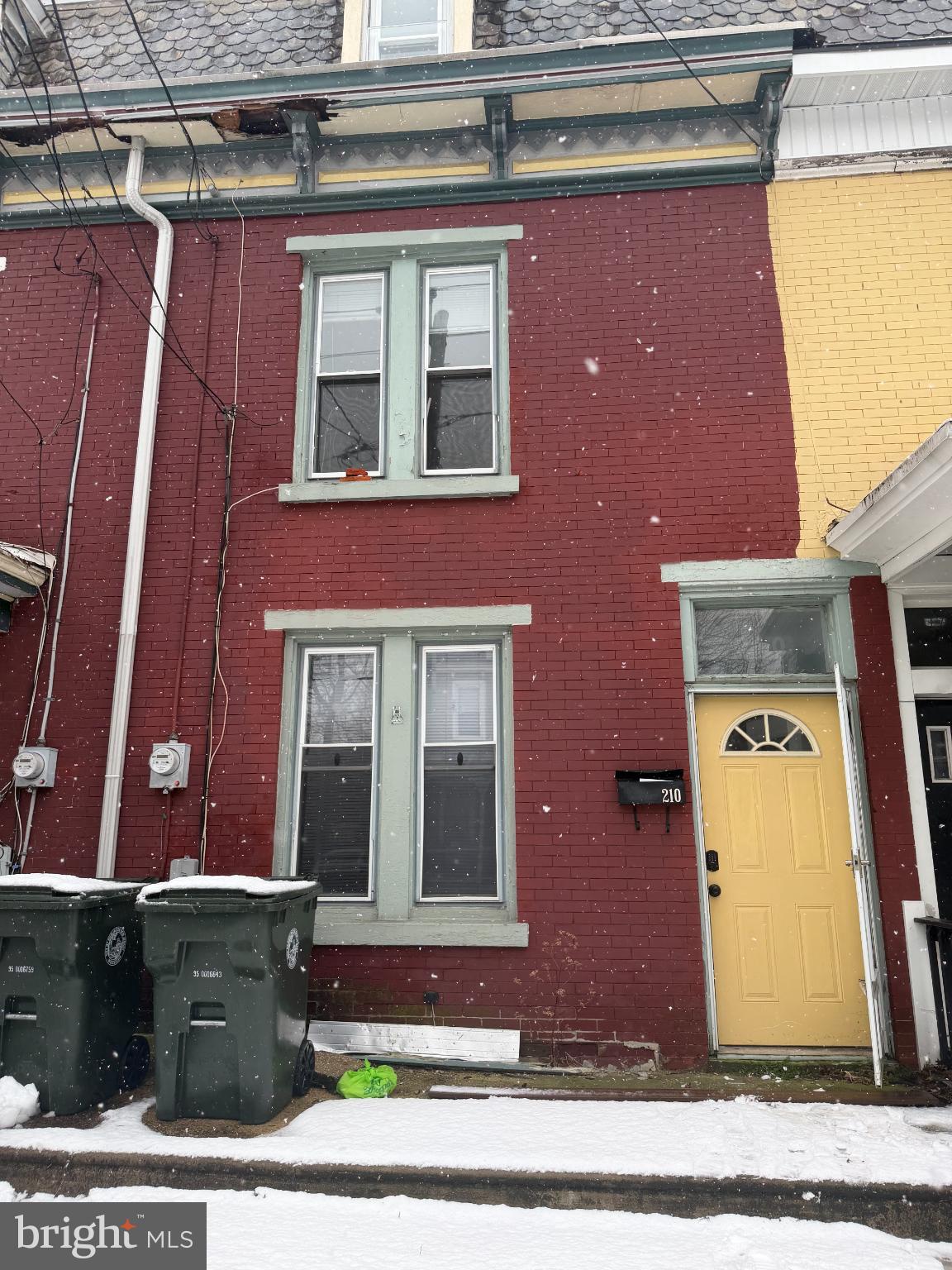 Charming brick facade in a snowy setting.
