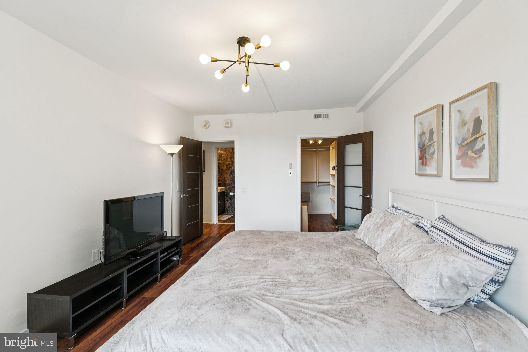 191 Presidential Boulevard, Unit R724 Bala Cynwyd, PA 19004 - Photo 12 of 19 a bedroom with a bed and a flat screen tv