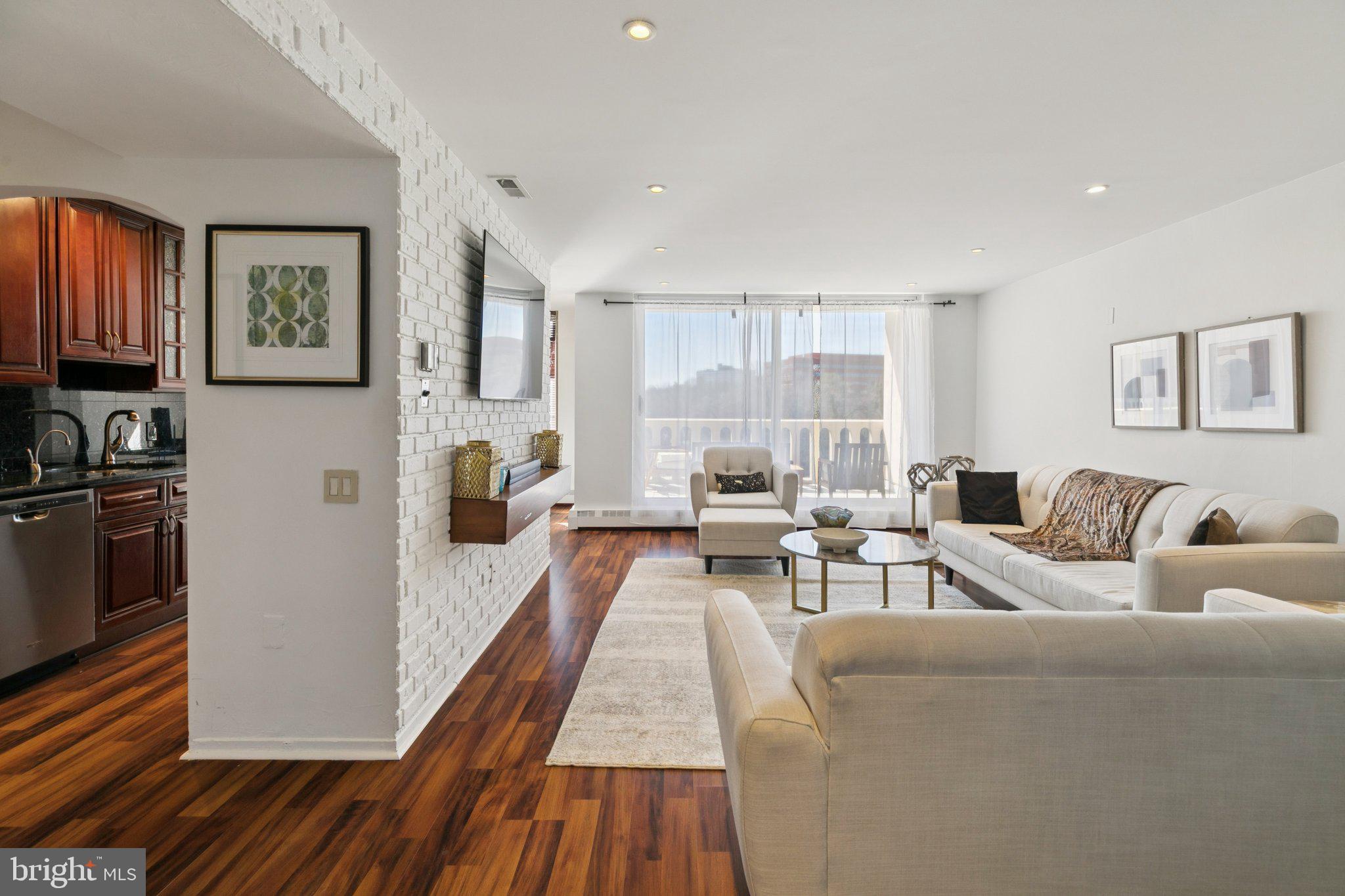 191 Presidential Boulevard, Unit R724 Bala Cynwyd, PA 19004 - Photo 2 of 19 a living room with furniture and a fireplace