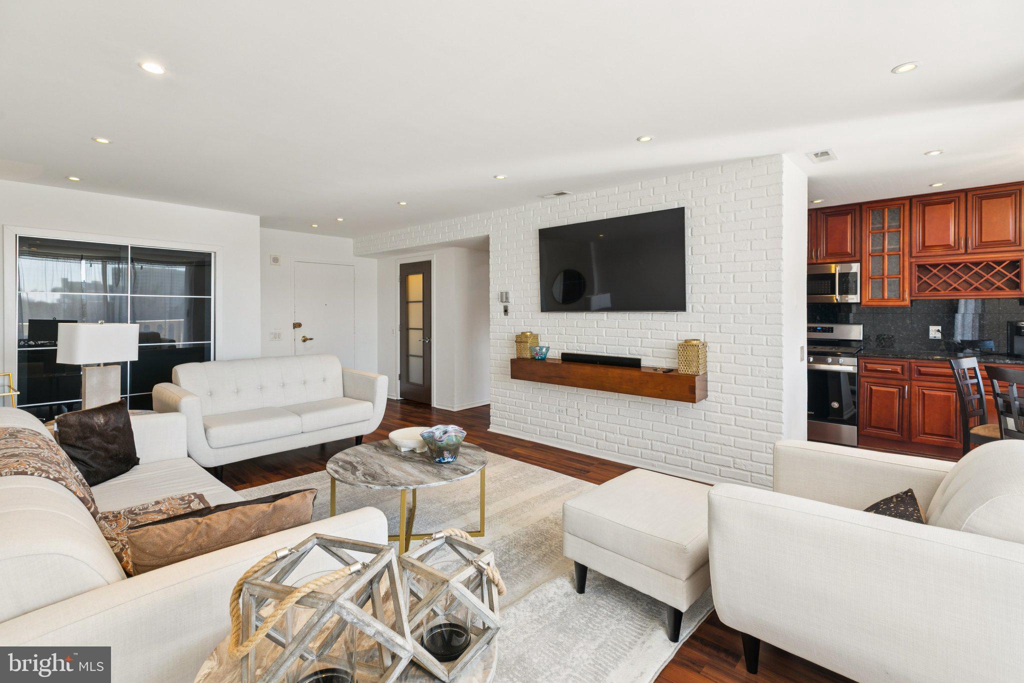 191 Presidential Boulevard, Unit R724 Bala Cynwyd, PA 19004 - Photo 4 of 19 a living room with furniture and a flat screen tv