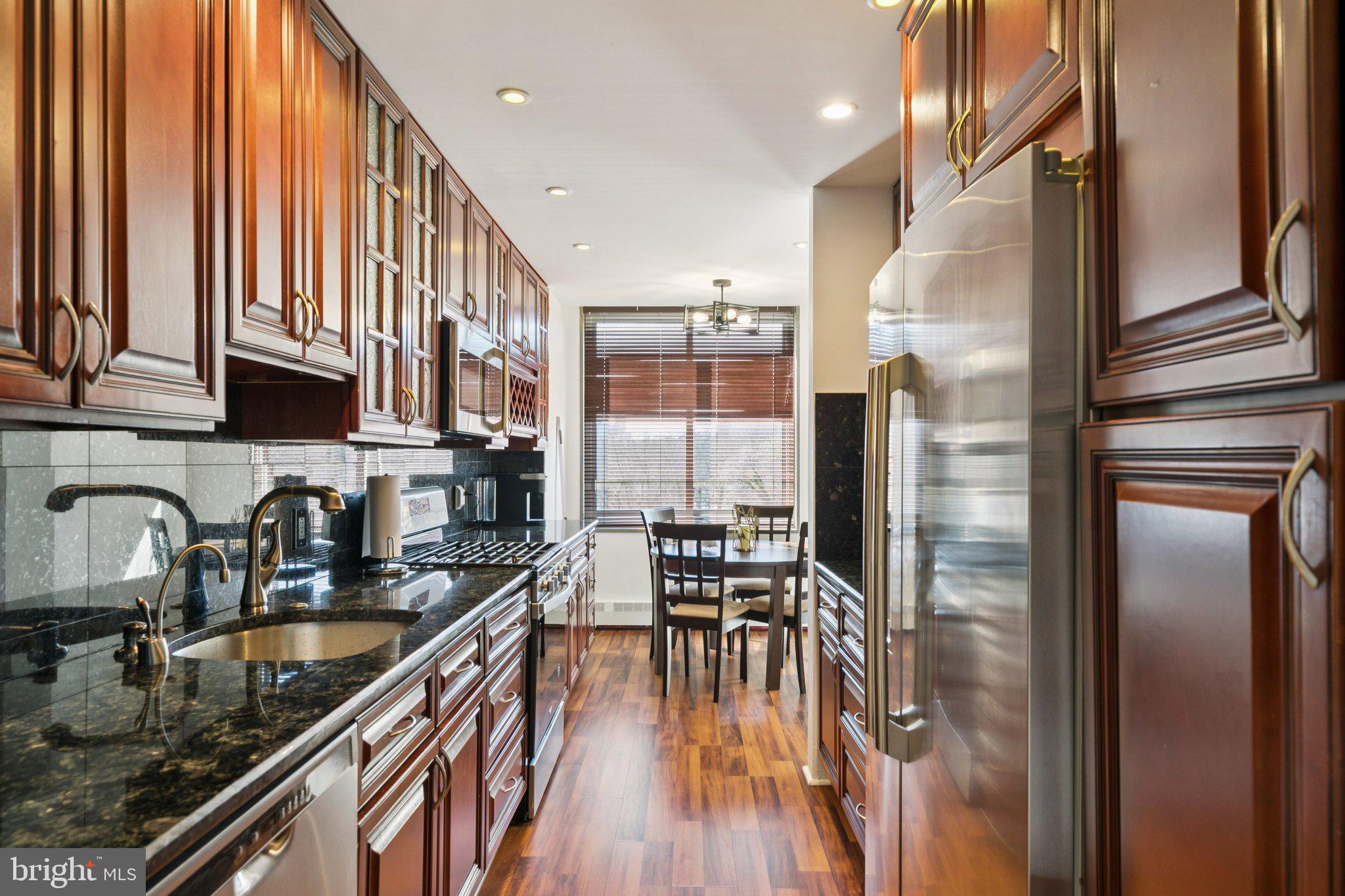 191 Presidential Boulevard, Unit R724 Bala Cynwyd, PA 19004 - Photo 5 of 19 a kitchen with stainless steel appliances granite countertop a refrigerator a sink a stove and white cabinets