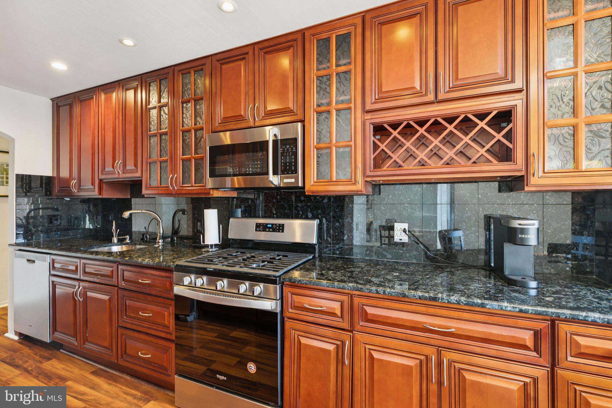 191 Presidential Boulevard, Unit R724 Bala Cynwyd, PA 19004 - Photo 7 of 19 a kitchen with stainless steel appliances granite countertop a stove a sink and a microwave
