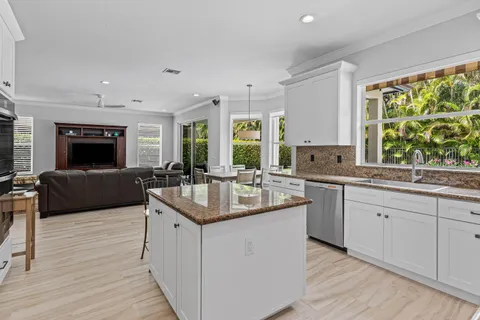 a kitchen with stainless steel appliances granite countertop a sink and a stove